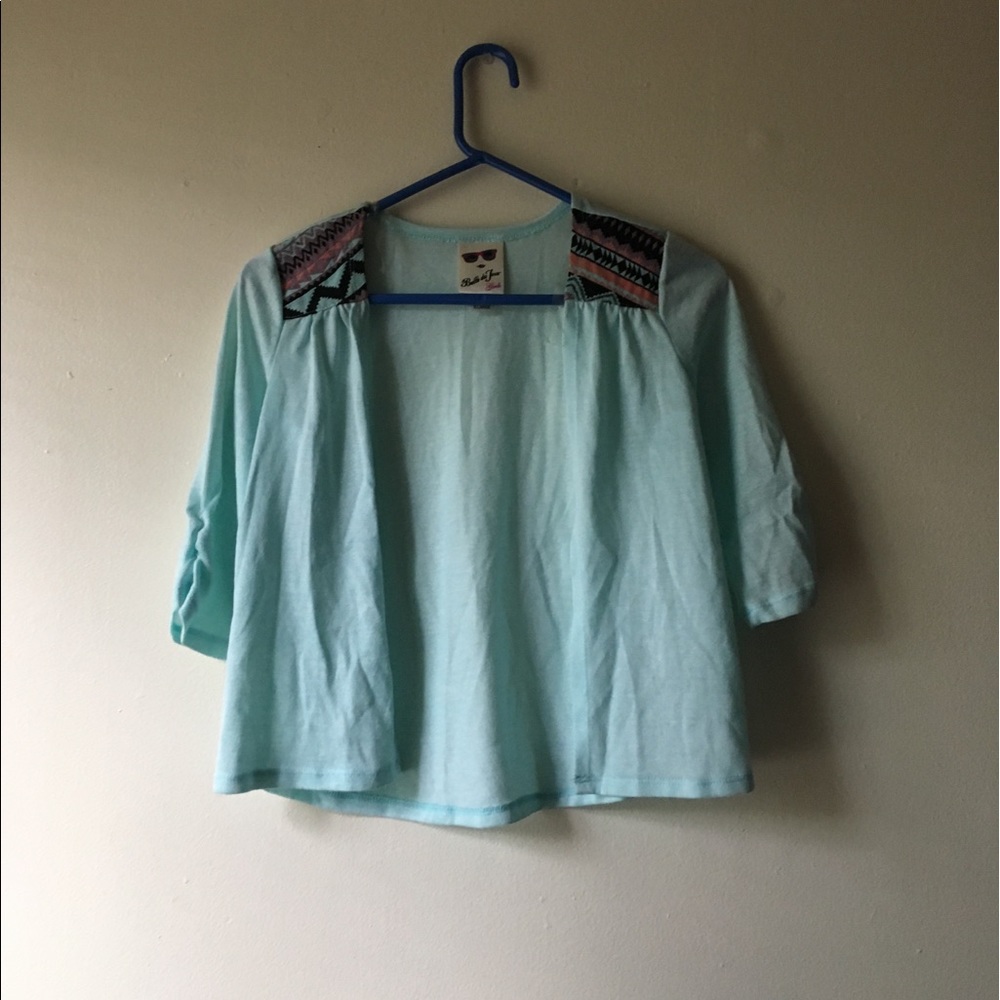 Light blue cardigan with design on shoulder